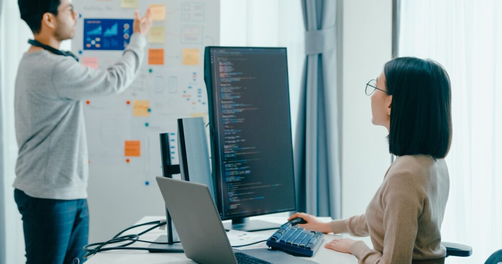 Software developers mentor leader manager talk strategy plan to executive write prompt AI bot.