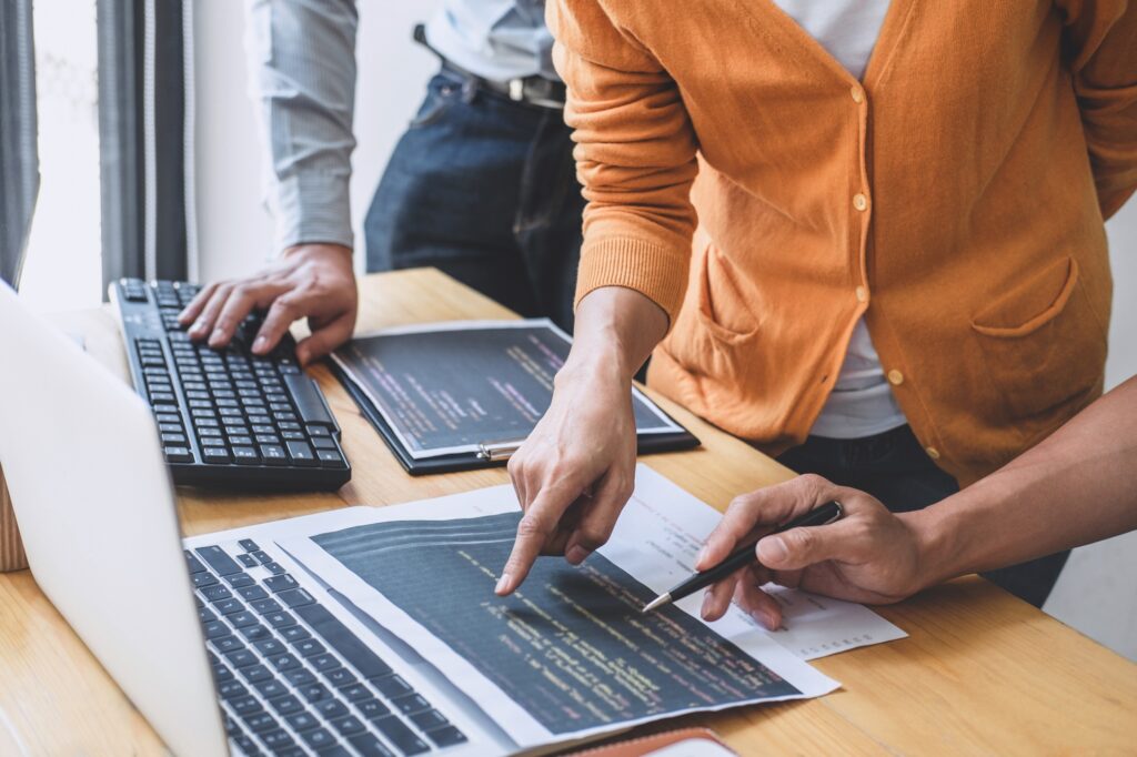 Team professional programmer cooperating and working on web site project in a software developing on